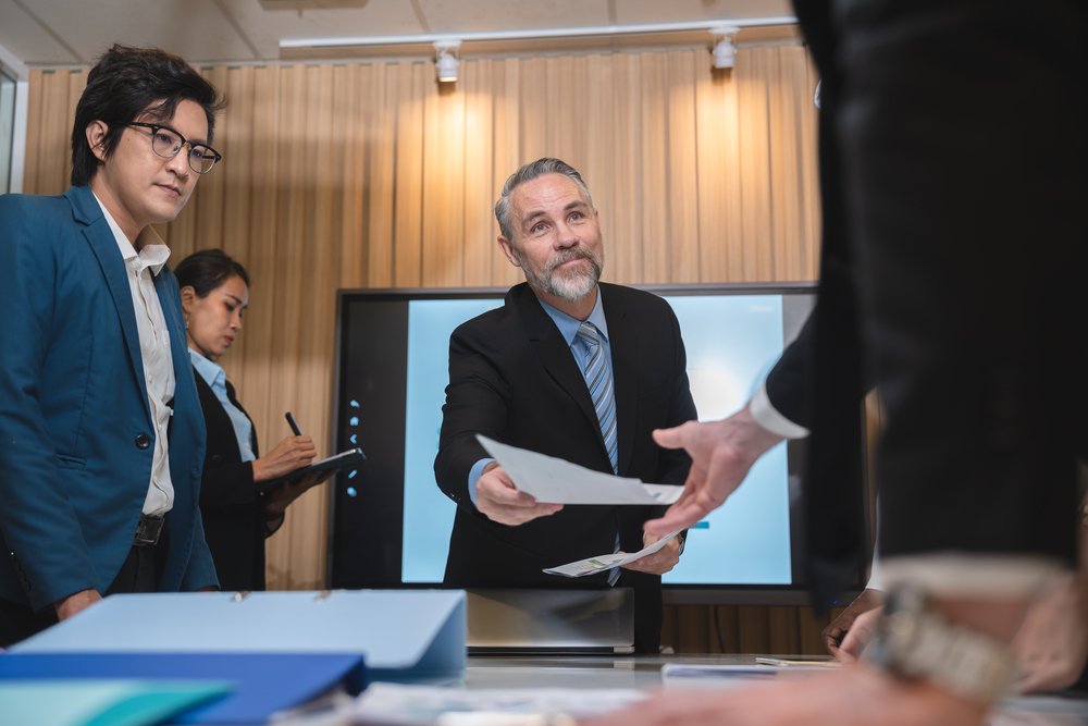 Group Of Businesspeople Sitting Together In A Meet YMGR4TB